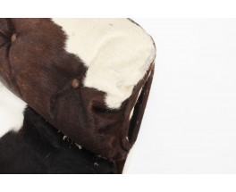 Fauteuil et repose-pieds en peau de vache 1970